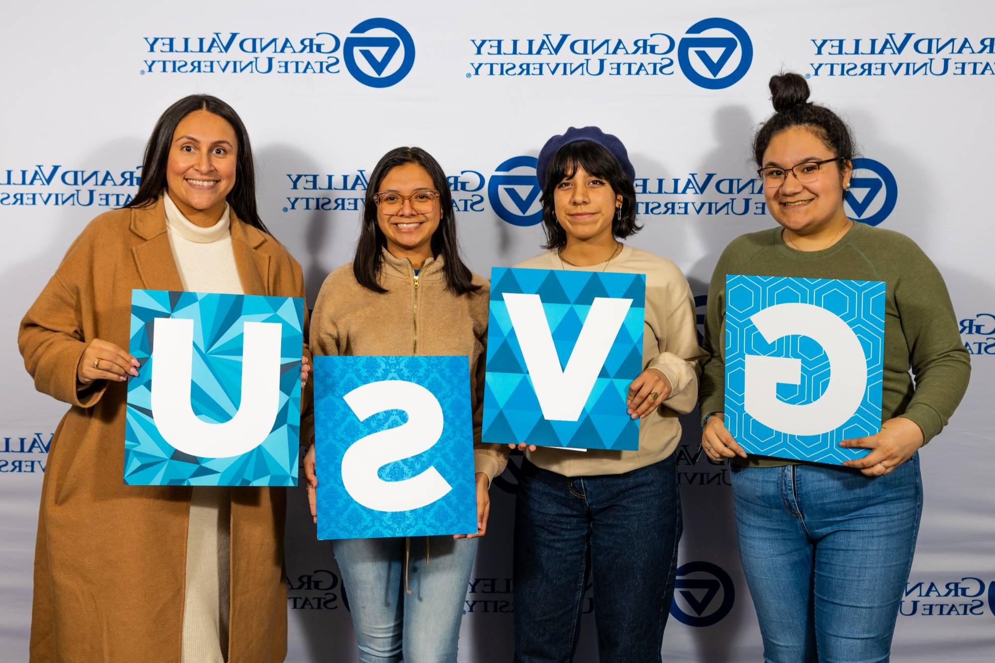 Students holding GVSU letters